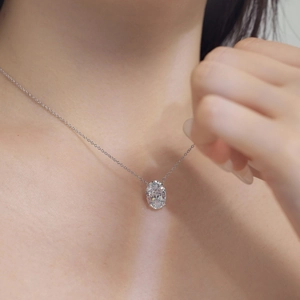Detail of S925 sterling silver necklace with oval cut cubic zirconia on neck