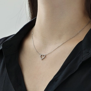 Close-up of S925 sterling silver heart necklace featuring pavé-set cubic zirconia stones