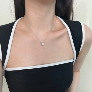 Close-up of S925 sterling silver necklace with ice-cut zircon pendant on woman neck