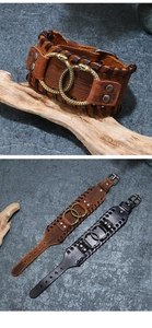 Close-up of punk leather bracelet with double metal snake rings and rustic stitching