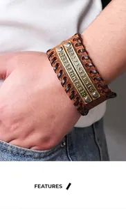 Macro shot of Viking rune metal plates on a brown braided leather bracelet