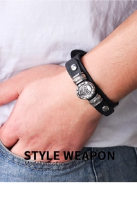 Close-up of punk style multilayer black leather bracelet with silver skull and wrench detail