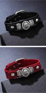 Detail of adjustable punk leather bracelets with skull charms and buckle closure
