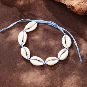 Handmade bohemian anklet with white cowrie shells on adjustable sky blue cord