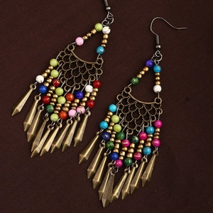 Detailed shot of bohemian long tassel earrings with colorful beads and antique metal finish