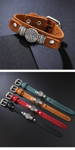 Close-up detail of vintage leather bracelets with Tree of Life metal charms and rustic textures