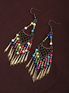 Detailed shot of ethnic long tassel earrings with colorful beads and antique bronze finish