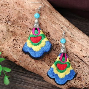 Bohemian embroidered drop earrings with colorful floral stitching and blue turquoise beads