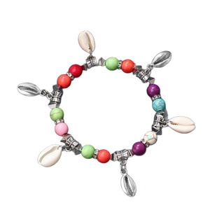 Bohemian multicolored beaded bracelet featuring shell charms and turquoise accents