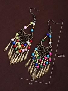 Detailed view of long bohemian tassel earrings with colorful beads and bronze metal charms