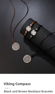 Detail of vintage silver Vegvisir compass pendant on black and brown leather cord