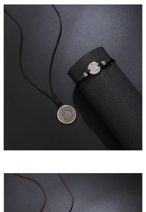 Detail of Viking Vegvisir compass pendant and woven leather cord with metal spacers