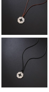 Detailed view of stainless steel compass star pendant with braided black and brown cords