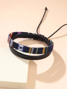 Detail of bohemian hand-woven cotton linen bracelet with multi-color ethnic stripes