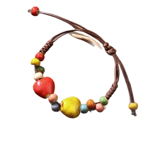 Ethnic ceramic woven bracelet with colorful heart-shaped beads and brown cord