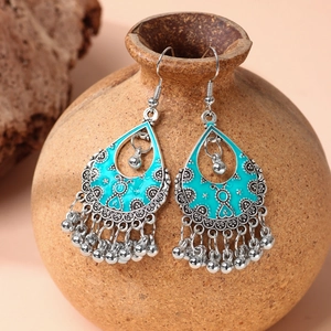 Bohemian silver drop earrings with blue enamel patterns and metallic fringe beads