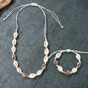 Handmade shell necklace and bracelet set with daisy floral charms for beach vacations