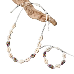 Handmade shell necklace and bracelet set with painted daisy charms on white background