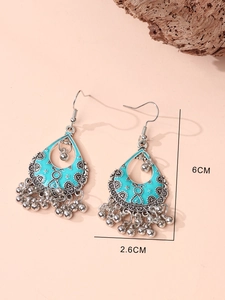 Detail view of bohemian turquoise drop earrings with size markers 6cm by 2.6cm
