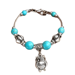 Bohemian turquoise beaded bracelet featuring a vintage owl charm and heart lock pendant