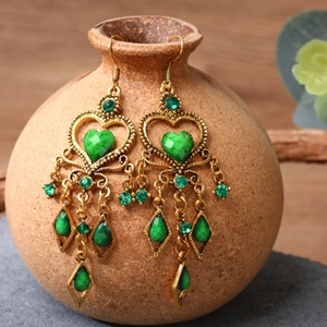 Bohemian dangle earrings with green rhinestones and tassel charms in antique gold finish