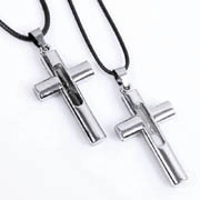 Detailed view of two silver cross necklaces with polished hollow design and black cord