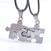 Matching puzzle couple necklaces with crystal moon design and black cord straps
