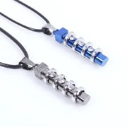 Close-up of geometric pillar pendants with blue and silver accents and inlaid rhinestones