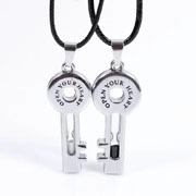 Detail of silver key pendants with Open Your Heart engraving and black cord