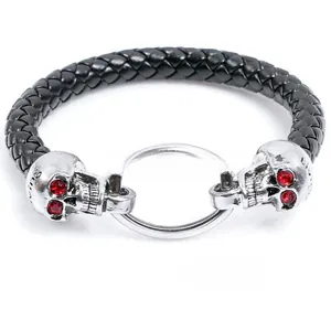 Macro detail of punk skull leather bracelet with ruby-inlaid eyes and silver metal rings