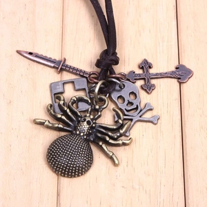 Gros plan du collier punk gothique avec araignée en bronze et pendentifs crâne sur cuir