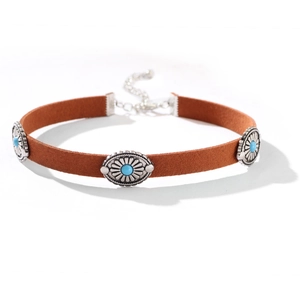 Detail of brown suede choker featuring vintage silver ornaments and turquoise stones