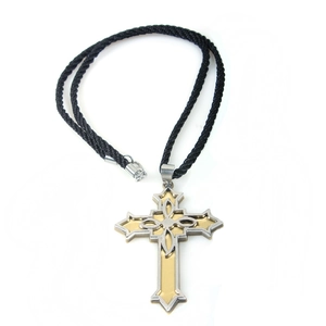 Macro detail of Victorian cross pendant with gold-silver plating and woven cord