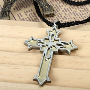 Detailed view of Victorian cross pendant with amber resin inlay and woven cord