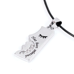 Detail of silver moon pendant with rhinestones and Has been selected engraving