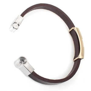 Close-up of brown leather punk bracelet with silver buckle and gold metal plate detail