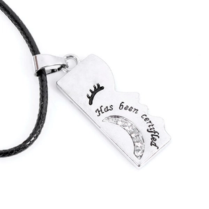 Detailed close-up of a silver crescent moon pendant with rhinestones and black cord