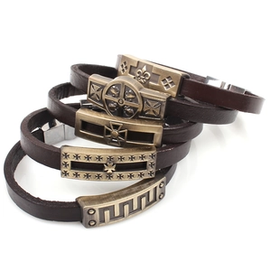 Detail view of 5-piece punk leather bracelets with cross and skull metal charms