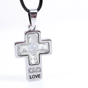 Macro shot of silver cross pendant with skull relief and LOVE engraving on black cord