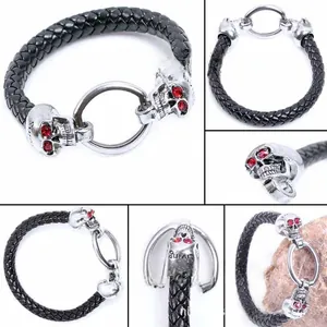 Macro detail of punk skull leather bracelet with red crystal eyes and metal ring