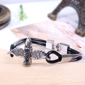 Detail of punk style black double-cord bracelet with silver wing and LOVE engraving