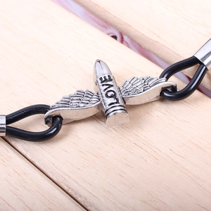 Punk style silver wing bullet LOVE bracelet with black double-cord strap on wood
