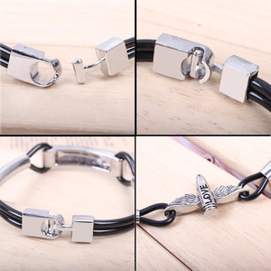 Detail of PU leather wing bracelet with silver LOVE charm and metal magnetic buckle