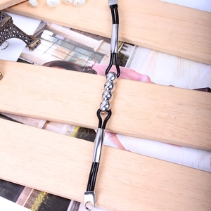 Detail of minimalist black PU leather cord bracelet with polished silver metal beads