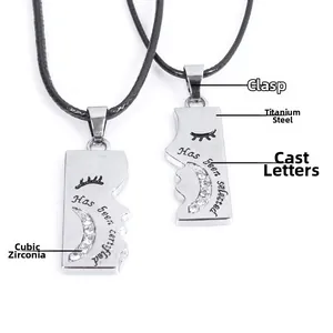 Detail of moon-themed couple pendants with sparkling rhinestones and engraved lettering