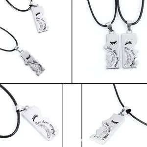 Close-up of matching puzzle couple necklaces with engraved text and small zircons