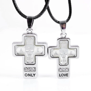 Punk cross pendant with skull design and ONLY LOVE engraving on black woven cord