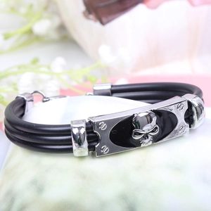 Detail of punk style multi-layer bracelet with skull relief and metal buckle