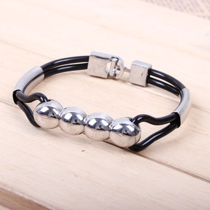 Close-up of a double-strand black PU leather bracelet featuring four polished silver beads