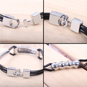 Detail view of multi-layer black PU bracelet with silver T-lock and metal beads